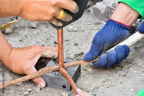 Workers are working connect  ground wire protection system.