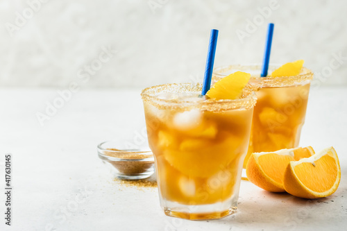 Honey orange iced green tea, summer cold cocktails in glasses. Space for text.