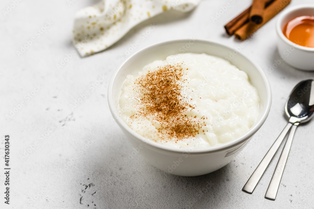 Cinnamon rice pudding in bowls. Space for text.