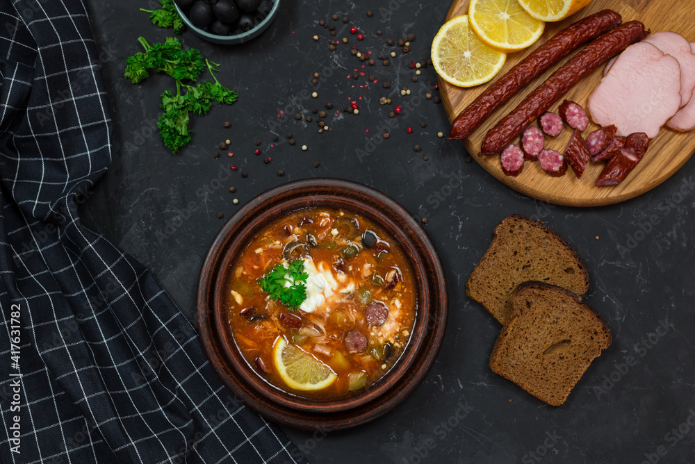 a national dish of Russian and Ukrainian cuisine. meat soup with pickles, olives, onions and lemon. with sour cream 