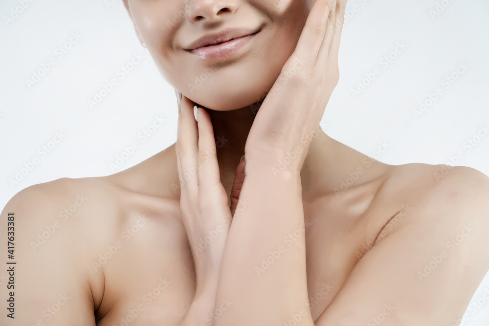 Natural beauty. Close up of a woman's smile, bare shoulders and clear and radiant skin Natural beauty. Close up of a woman's smile, bare shoulders and clear and radiant skin