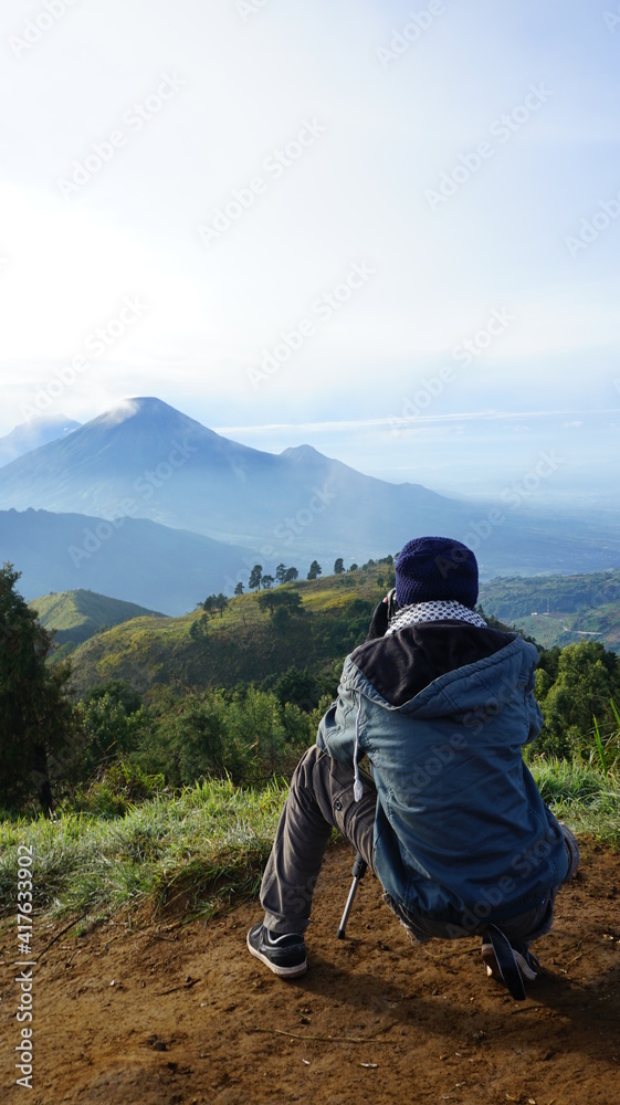 the photographer is photographing the mountain from the top of mount prau