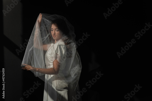 boudoir portrait of a young girl in a dressing gown, morning gatherings of the bride, fitting a wedding dress, young brunette, tender photo, wedding portrait