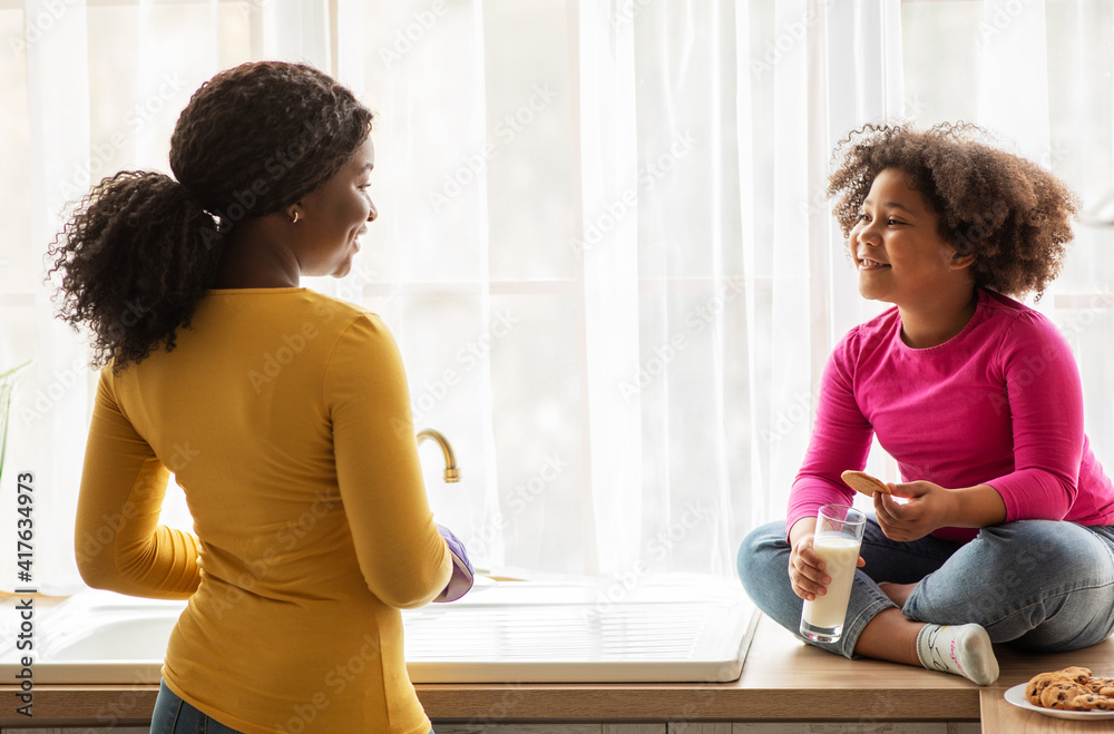 Happy African American Mom And Little Daughter Spending Time Together In Kitchen