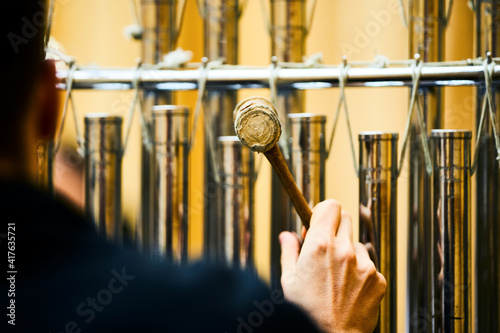 Man playing tubular bells. Tubular bells being played by percussionist. photo