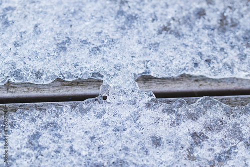 Crystals of meiling snow in the March in the  begining of spring on flat terrace board photo