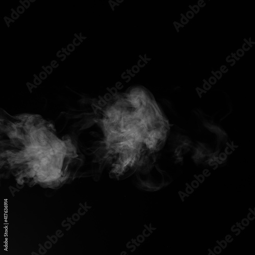 White smoke on black background. Figured smoke on a dark background. Abstract background, design element, for overlay on pictures