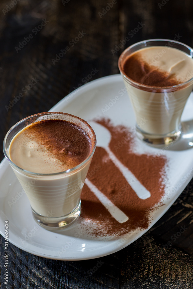 coffee ricotta, spoon dessert in glass cup served in a white plate coffee ricotta, spoon dessert in glass cup served in a white plate