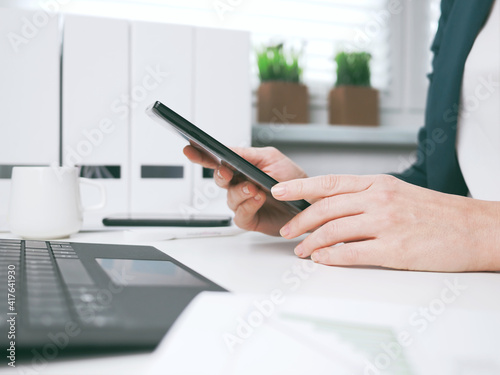 Obraz na płótnie young woman typing on smartphone. Home office, online business marketing or learning concept. Online shopping, booking and banking background with copy space. tax return w salonie