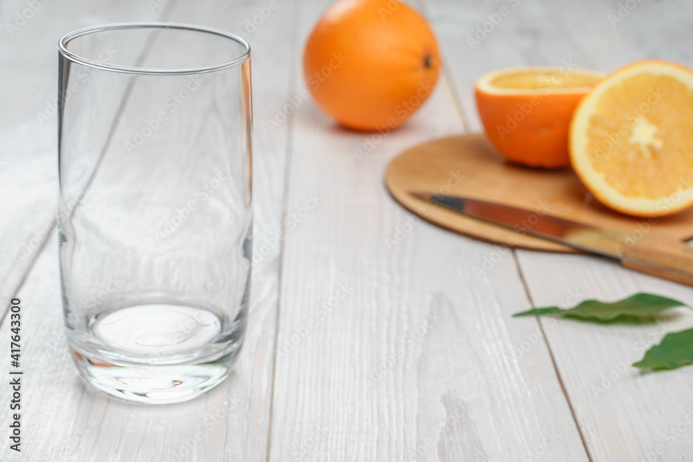 Empty glass and oranges in the background Empty glass and oranges in the background