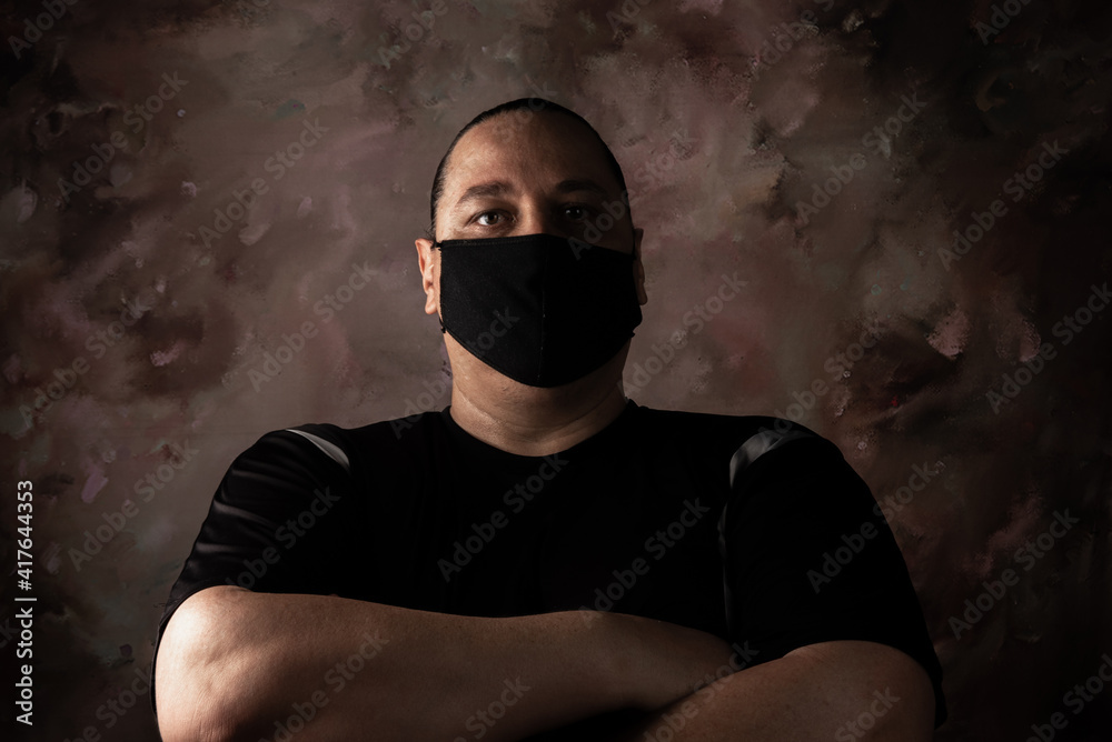Portrait of brazilian man wearing mask against covid-19, abstract background, selective focus Portrait of brazilian man wearing mask against covid-19, abstract background, selective focus