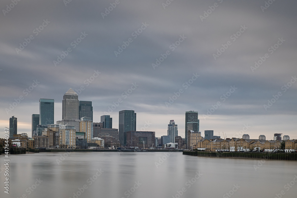 Cloudy sunrise in East London with Canary Wharf district in the background.
