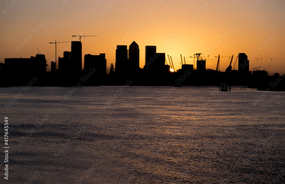 Sunset in East London with Canary Wharf district as a  silhouette.