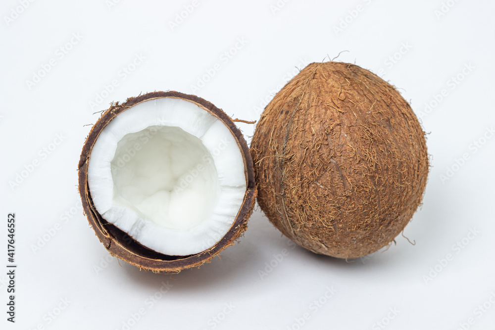 Isolated coconut on a white background. Whole and split coconut. Healthy food Isolated coconut on a white background. Whole and split coconut. Healthy food
