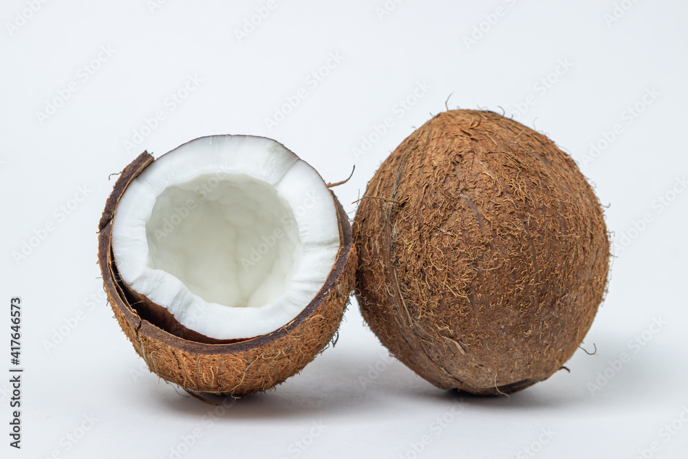 Isolated coconut on a white background. Whole and split coconut. Healthy food Isolated coconut on a white background. Whole and split coconut. Healthy food