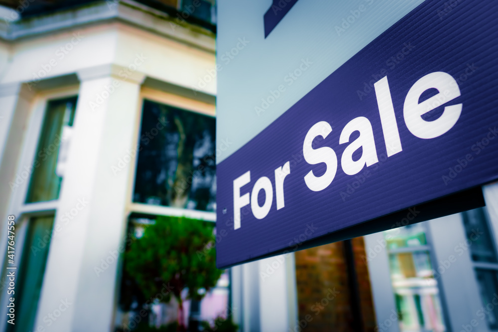 Estate agent For Sale sign on street of houses Estate agent For Sale sign on street of houses