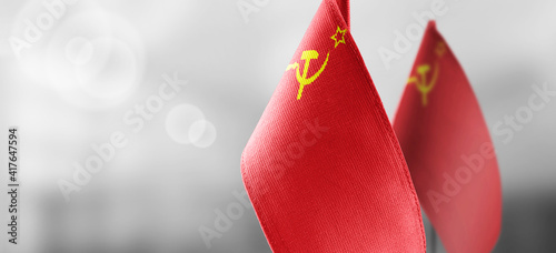 Small national flags of the USSR on a light blurry background
