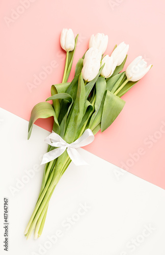 Top view of white tulips on double colored background © dark_blade