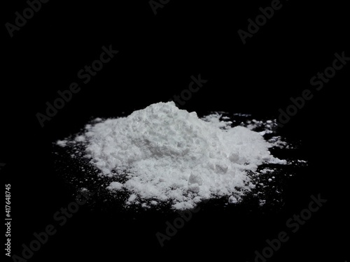 Cocaine drug powder pile on black background