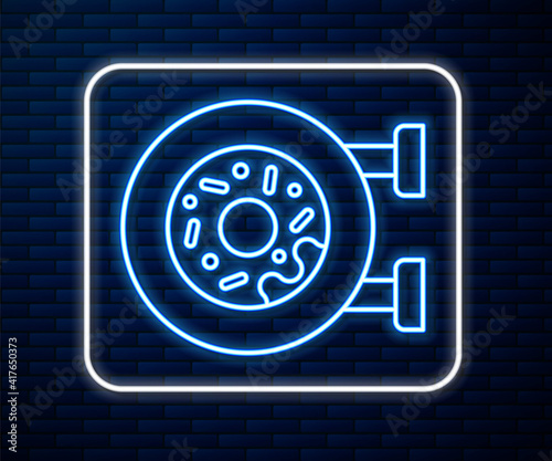 Glowing neon line Donut with sweet glaze icon isolated on brick wall background. Vector.