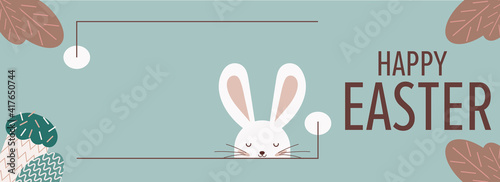 greeting card in gentle colors with Easter. Place for congratulations, white rabbit, egg and cupcake surrounded by plants