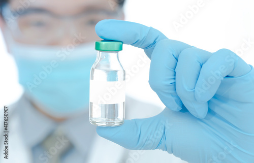 vaccines fight against virus, doctor or scientist in laboratory holding a syringe with liquid vaccines.