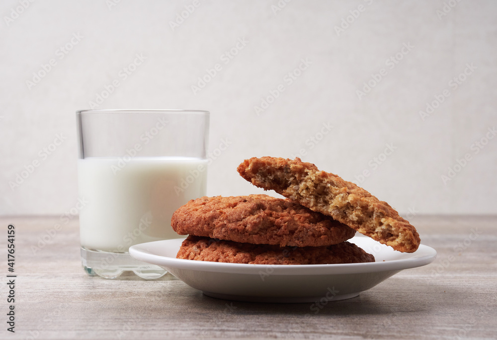 Homemade shortbread kamut cookies with glass of milk on light background Homemade shortbread kamut cookies with glass of milk on light background