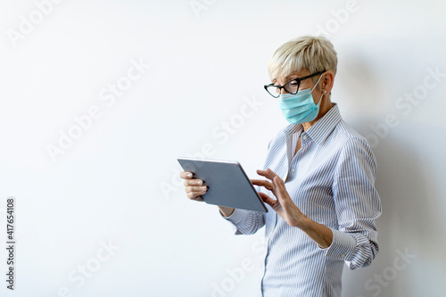 Mature businesswoman using ...