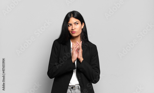 Fotografie, Obraz young hispanic businesswoman feeling proud, mischievous and arrogant while schem