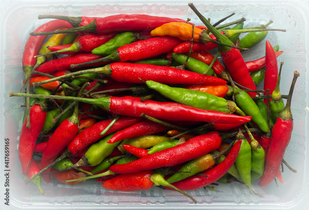 The picture above forms a close-up of red chili peppers as a food or vegetable seasoning or spicy spice for cooking in a background image.