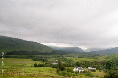 Scenic Landscape View of Mountain and house near the lake, in Scottish Highland.