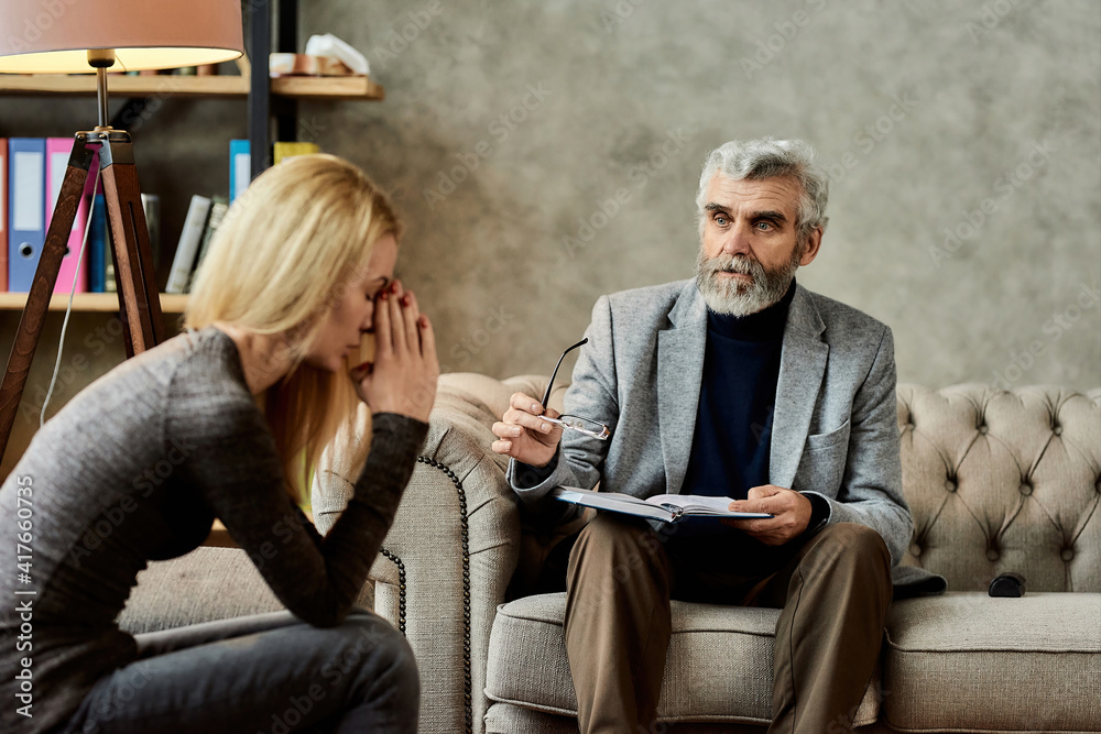 Psychotherapist supporting young woman during appointment Psychotherapist supporting young woman during appointment