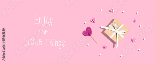 Enjoy the little things message with a small gift box and paper hearts