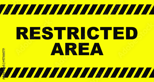 Restricted area sign on yellow background