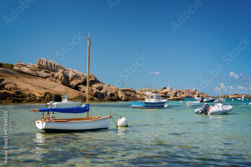 Boats and transparent water on Coz-Pors beach in Tregastel, Côtes d'Armor, Brittany, France photo