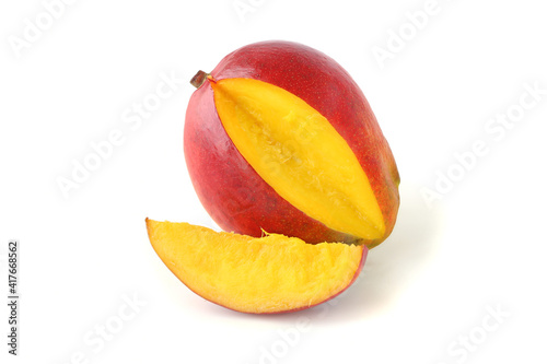Cut mango with a slice isolated on white