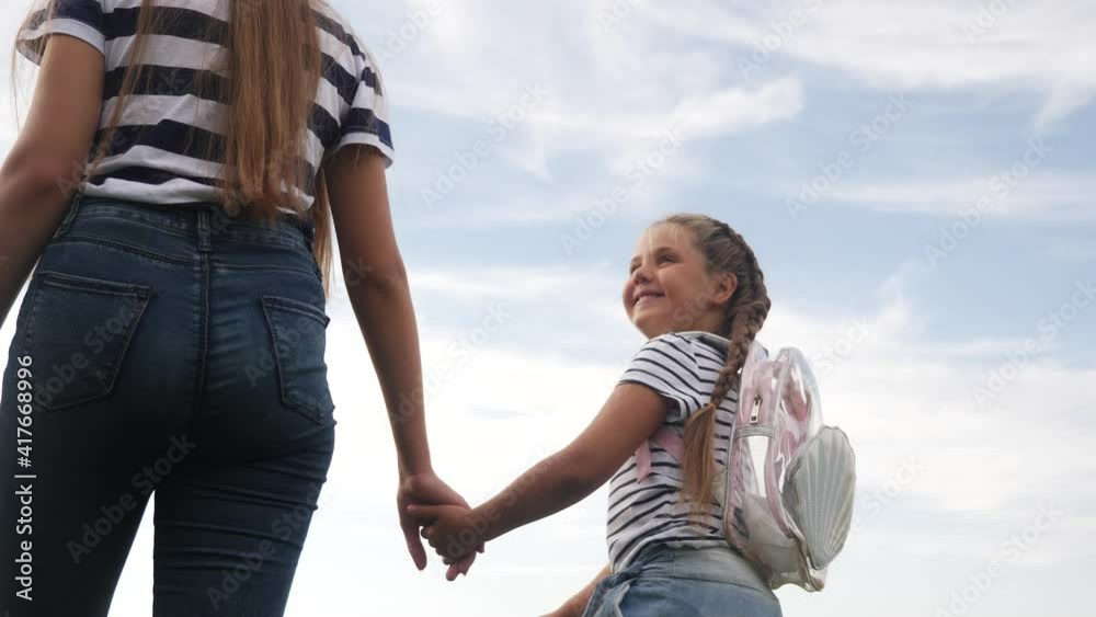 happy family mom and daughter are walking in the park. kid dream concept. happy family walking in the park leisure friendly lifestyle family. mother and daughter are resting in nature happy family mom and daughter are walking in the park. kid dream concept. happy family walking in the park leisure friendly lifestyle family. mother and daughter are resting in nature