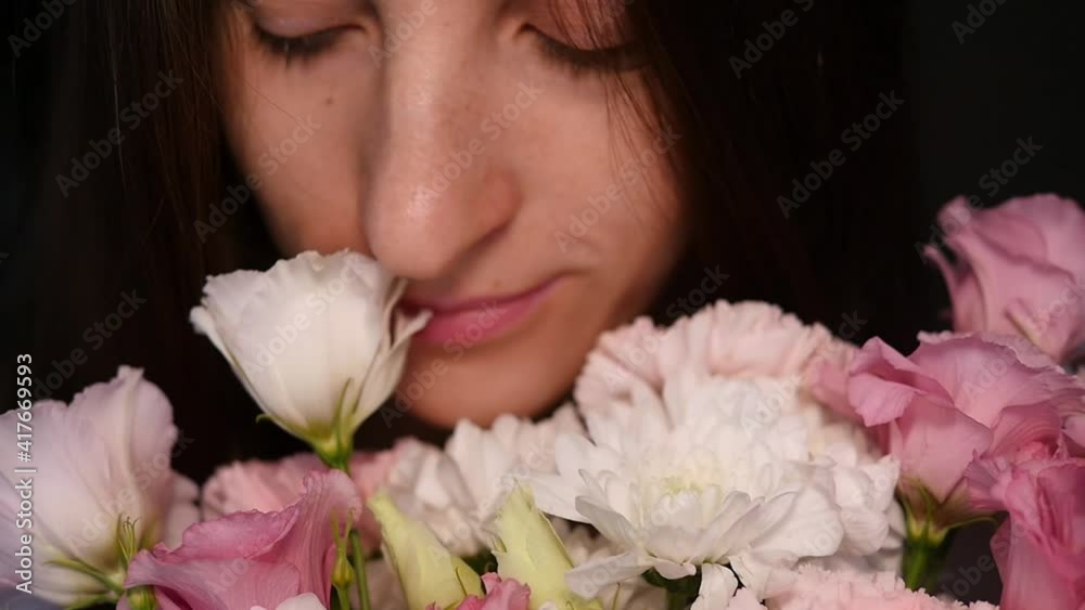 Pretty young woman enjoys a bouquet of fresh flowers. A calm and peaceful woman sniffs flowers and enjoys life. Holiday concept 8 march, love day, mother's day Pretty young woman enjoys a bouquet of fresh flowers. A calm and peaceful woman sniffs flowers and enjoys life. Holiday concept 8 march, love day, mother's day