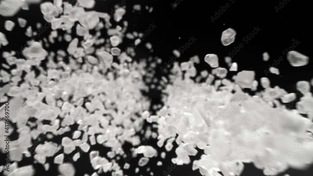 Super Slow Motion Detail Shot of Salt Falling on Black Background at 1000fps. Super Slow Motion Detail Shot of Salt Falling on Black Background at 1000fps.