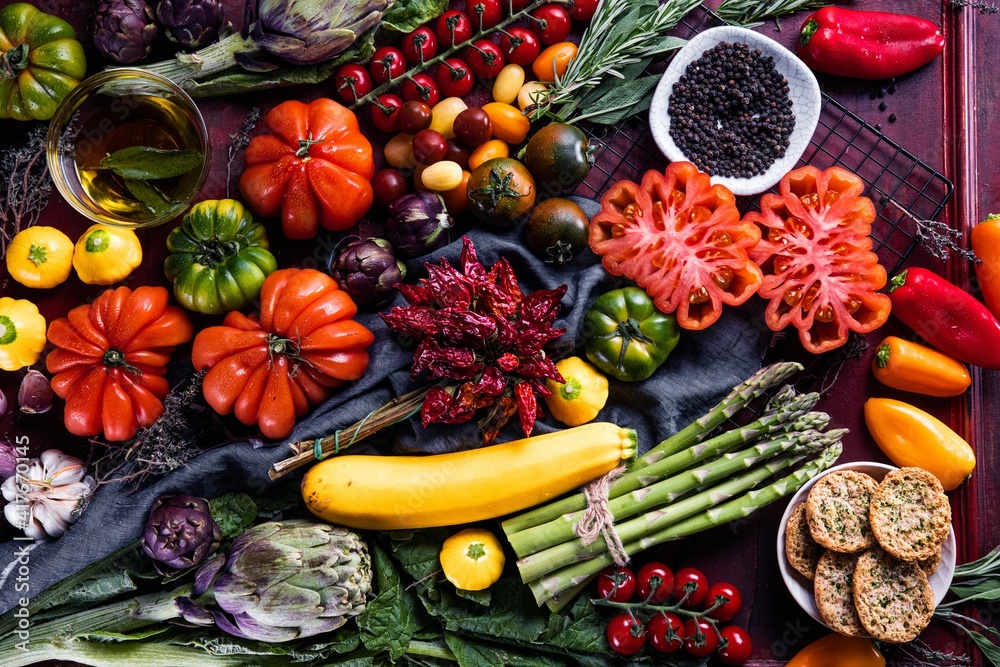 Composition with raw vegetables asparagus and ox heart tomatoes