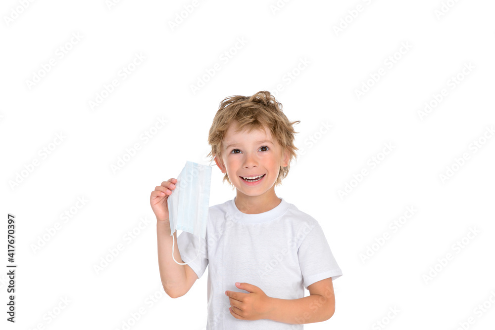 Smiling boy with protective medical mask removed Smiling boy with protective medical mask removed