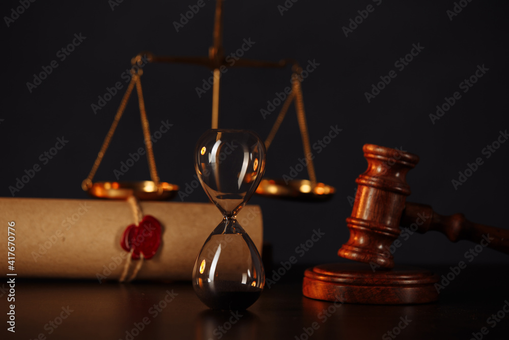 Wooden gavel, hourglass and stamp on testament and last will on wooden table. Notary public tools. Wooden gavel, hourglass and stamp on testament and last will on wooden table. Notary public tools.
