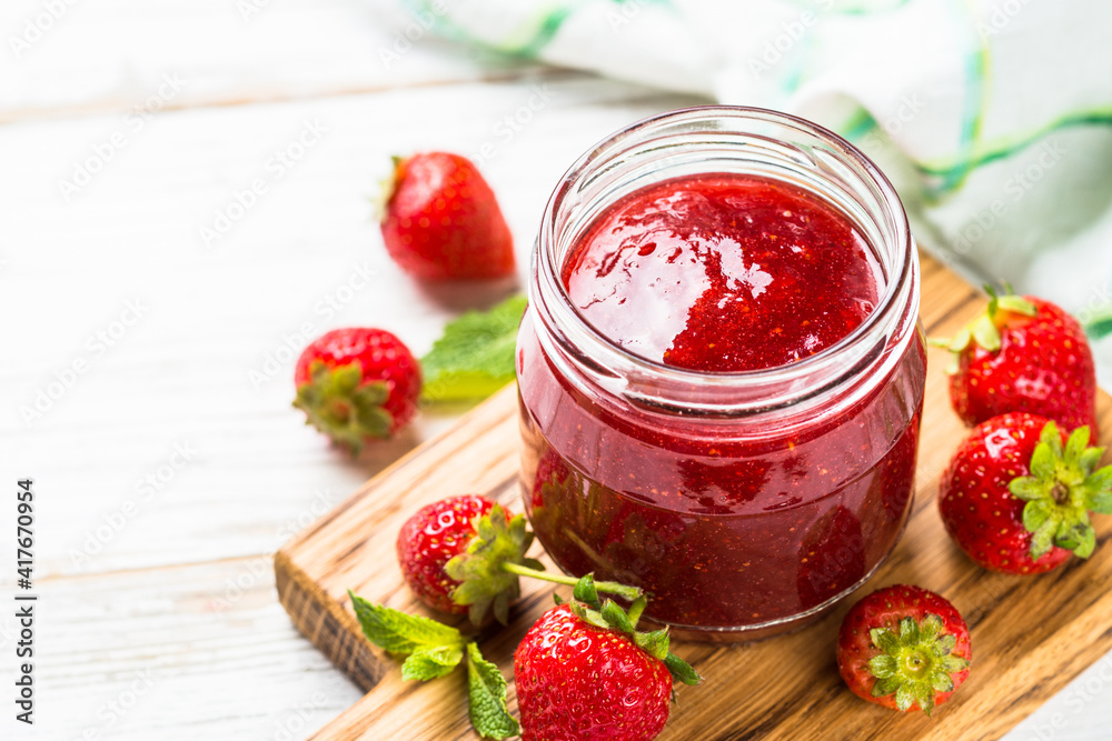 Strawberry jam in the glass jar with fresh berries. Close up. Strawberry jam in the glass jar with fresh berries. Close up.