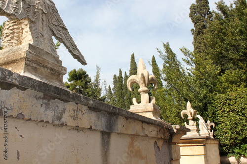 stone fence element with French lilies at Villa Deste. Italy
 photo