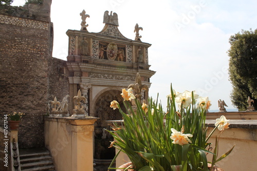 stone fence element with French lilies at Villa Deste. Italy
 photo