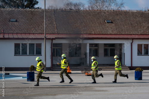 firefighters in the action of extinguishing fires and rescuing injured people