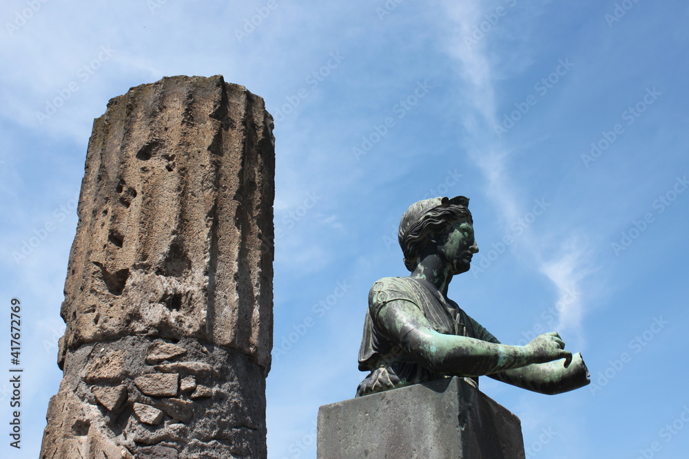 Ancient column and sculpture . Pompeii. Italy
