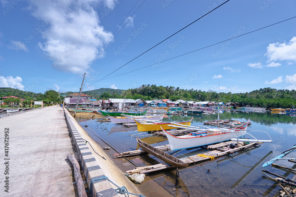 Landscape with pier and fishing boats. Siargao, Philippines.