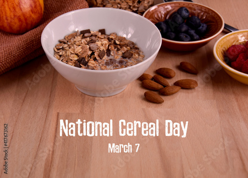 National Cereal Day stock images.  Healthy breakfast with muesli and fruits stock images. Bowl of granola with milk and fruits on the table stock photo. Cereal Day Poster  March 7. Important day