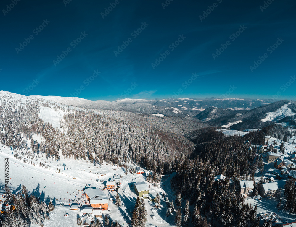 Light winter day at Carpathian mountains. Panoramic view on peaks